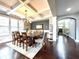 Bright dining room with hardwood floors, coffered ceilings, and an arched doorway at 4071 Woodward Walk Ln, Suwanee, GA 30024