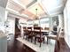 Dining area with hardwood floors, coffered ceilings and view of fireplace at 4071 Woodward Walk Ln, Suwanee, GA 30024