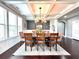 Formal dining room with coffered ceiling, large windows, and hardwood floors at 4071 Woodward Walk Ln, Suwanee, GA 30024