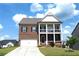 Charming two-story brick home with a double porch and well-manicured lawn at 4071 Woodward Walk Ln, Suwanee, GA 30024