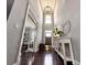 Two-story foyer with hardwood floors, neutral paint, and modern decor at 4071 Woodward Walk Ln, Suwanee, GA 30024
