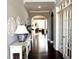 Well-lit foyer with hardwood floors, console table, and decorative mirrors at 4071 Woodward Walk Ln, Suwanee, GA 30024