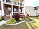 The front of the house is well landscaped with green grass, plants, and decorative rock edging at 4071 Woodward Walk Ln, Suwanee, GA 30024