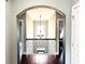 Hallway featuring beautiful archway, hardwood floors and decorative light fixture, adding architectural charm at 4071 Woodward Walk Ln, Suwanee, GA 30024