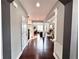 Hallway with hardwood floors leading to an open-concept living area at 4071 Woodward Walk Ln, Suwanee, GA 30024