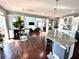 Open-concept living area featuring hardwood floors, a kitchen island, and seamless transition between spaces at 4071 Woodward Walk Ln, Suwanee, GA 30024