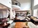 Bright living room with hardwood floors, view of the kitchen, and upstairs balcony at 4071 Woodward Walk Ln, Suwanee, GA 30024