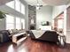 Living room with hardwood floors, stone fireplace, and tall windows at 4071 Woodward Walk Ln, Suwanee, GA 30024