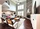 Living room with hardwood floors, a fireplace, and views of the kitchen at 4071 Woodward Walk Ln, Suwanee, GA 30024