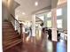 Bright living room featuring hardwood floors, white pillars, and an open floor plan leading to the kitchen at 4071 Woodward Walk Ln, Suwanee, GA 30024