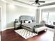 Spacious main bedroom featuring a gray bedframe, trey ceiling with fan, and light gray walls at 4071 Woodward Walk Ln, Suwanee, GA 30024