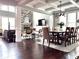 Open-concept living with hardwood floors, fireplace, and dining area at 4071 Woodward Walk Ln, Suwanee, GA 30024