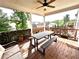 Covered outdoor deck featuring a picnic table, benches, and privacy screening, ideal for outdoor dining and relaxation at 4071 Woodward Walk Ln, Suwanee, GA 30024