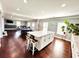 Entertaining area offering a center island with seating, hardwood flooring, and a recreation space at 4071 Woodward Walk Ln, Suwanee, GA 30024