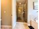 Tiled walk-in shower with glass door, next to the bathtub in the main bathroom at 4071 Woodward Walk Ln, Suwanee, GA 30024