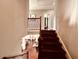 View from the top of the stairs looking down to a light-filled dining room with hardwood floors at 4071 Woodward Walk Ln, Suwanee, GA 30024