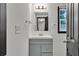 Bathroom featuring gray vanity with white countertop, mirror and modern fixtures at 4576 Dorset Circle, Decatur, GA 30035