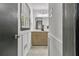 Bathroom showcasing gray tiling, a window, and white and light brown fixtures at 4576 Dorset Circle, Decatur, GA 30035