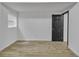 Empty bedroom featuring hardwood floors, a window, and a black door at 4576 Dorset Circle, Decatur, GA 30035