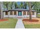 Charming painted brick home featuring a blue front door and shuttered windows at 4576 Dorset Circle, Decatur, GA 30035