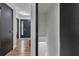 Hallway with dark doors and trim, light hardwood floors, and view of the front door at 4576 Dorset Circle, Decatur, GA 30035