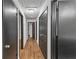 Hallway with hardwood floors leading to multiple rooms, painted black trim and doors at 4576 Dorset Circle, Decatur, GA 30035