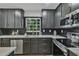 Modern kitchen features gray cabinetry, stainless steel appliances, white countertops, and a stylish backsplash at 4576 Dorset Circle, Decatur, GA 30035