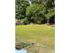 Well-maintained backyard with lush green grass and mature trees, perfect for outdoor enjoyment at 497 Natasha Dr, Auburn, GA 30011