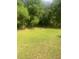 Large grassy backyard with mature trees and an open space great for recreation at 497 Natasha Dr, Auburn, GA 30011