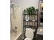 Compact bathroom featuring a shower, vanity with granite countertop, and storage at 497 Natasha Dr, Auburn, GA 30011