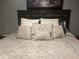 Comfortable bedroom featuring a beautifully adorned bed with many pillows and neutral color at 497 Natasha Dr, Auburn, GA 30011