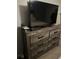 Bedroom features a TV, dresser, and carpet at 497 Natasha Dr, Auburn, GA 30011