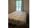 Bedroom featuring a neutral plaid comforter and natural light at 497 Natasha Dr, Auburn, GA 30011