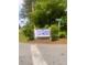 Community sign for Chauncey Creek neighborhood with lush green landscaping and street sign at 497 Natasha Dr, Auburn, GA 30011