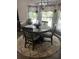 Cozy dining area filled with natural light with a round table, four chairs, and an overhead light fixture at 497 Natasha Dr, Auburn, GA 30011