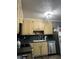 Traditional kitchen with custom cabinets, stainless steel appliances, and dark countertop provides ample space for cooking at 497 Natasha Dr, Auburn, GA 30011