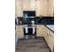 Updated kitchen with stainless steel oven, custom cabinets with dark hardware and countertops, and dark wood flooring at 497 Natasha Dr, Auburn, GA 30011