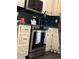 Updated kitchen with stainless steel stove, custom cabinets with dark hardware and countertops, and dark wood flooring at 497 Natasha Dr, Auburn, GA 30011