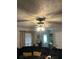 Comfortable living room featuring a ceiling fan, a dark sofa, and neutral decor at 497 Natasha Dr, Auburn, GA 30011