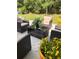 Patio area with comfortable wicker furniture and lush greenery, ideal for relaxation at 497 Natasha Dr, Auburn, GA 30011