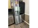 Stainless steel refrigerator/freezer combo features side by side design with water dispenser and black glass door at 497 Natasha Dr, Auburn, GA 30011
