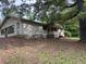 Exterior view of a ranch-style home with a covered porch and mature trees at 2368 Ebenezer Se Rd, Conyers, GA 30094