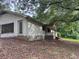 Exterior view of a ranch-style home with a covered porch and mature trees at 2368 Ebenezer Se Rd, Conyers, GA 30094