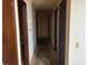 Hallway with doors, worn carpeting, and wall damage at 2368 Ebenezer Se Rd, Conyers, GA 30094