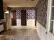 View of kitchen featuring patterned wallpaper, white appliances and beadboard walls at 2368 Ebenezer Se Rd, Conyers, GA 30094
