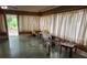 Living room featuring green tile flooring, wood paneling, and white curtains at 2368 Ebenezer Se Rd, Conyers, GA 30094