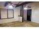 View of living room with two ceiling fans, large windows, and wall damage at 2368 Ebenezer Se Rd, Conyers, GA 30094