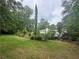 Expansive backyard surrounded by mature trees, offering privacy and a serene atmosphere at 3 Perthshire Dr, Peachtree City, GA 30269
