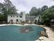 Lush backyard with a covered pool and patio space, perfect for outdoor entertaining at 3 Perthshire Dr, Peachtree City, GA 30269