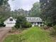 Charming home with a lush front lawn and attached garage, surrounded by mature trees at 3 Perthshire Dr, Peachtree City, GA 30269